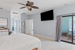 Master bedroom with large smart TV & private patio access